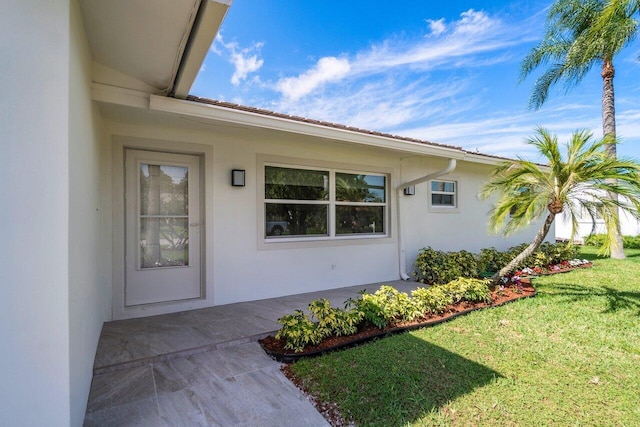 property entrance with a yard