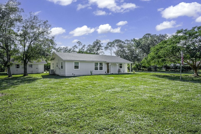 back of house with a lawn and central air condition unit