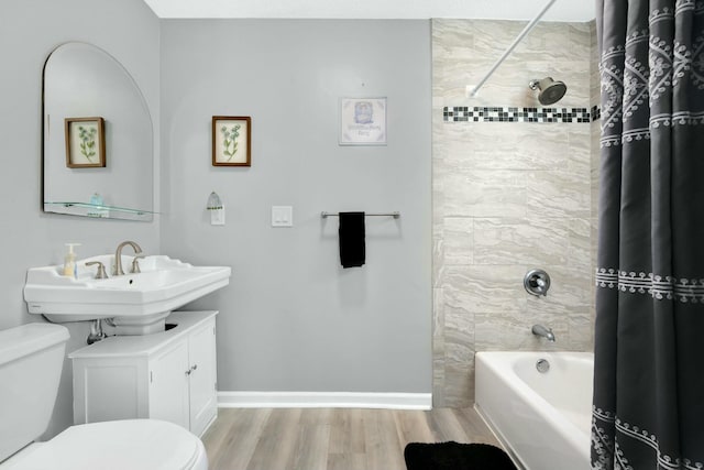 full bathroom featuring wood-type flooring, toilet, sink, and shower / bath combo