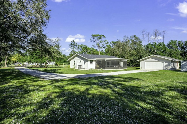 ranch-style home featuring a front lawn, a garage, and a sunroom