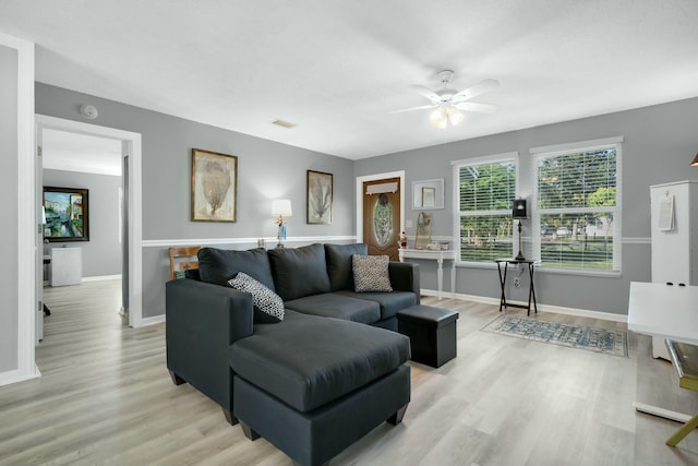 living room featuring ceiling fan and light hardwood / wood-style flooring