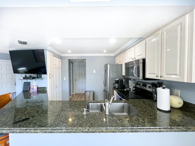 kitchen featuring white cabinetry, sink, dark stone countertops, stainless steel appliances, and crown molding