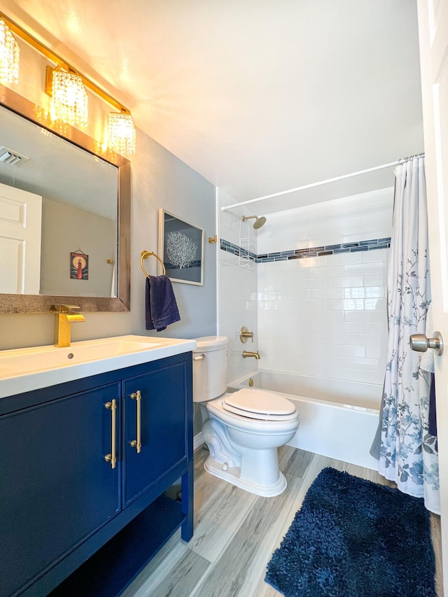 full bathroom featuring shower / bathtub combination with curtain, vanity, wood-type flooring, and toilet