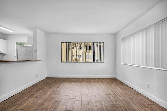 unfurnished room with wood-type flooring