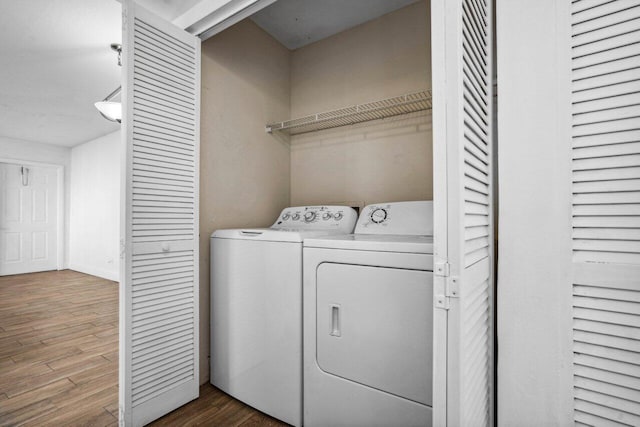 laundry room featuring hardwood / wood-style floors and washer and dryer