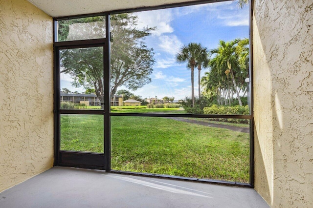 doorway with plenty of natural light and concrete flooring