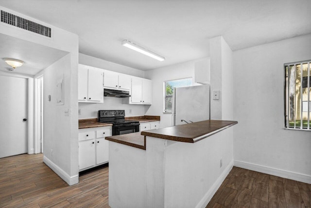 kitchen featuring white cabinetry, white refrigerator, dark wood-type flooring, kitchen peninsula, and black electric range