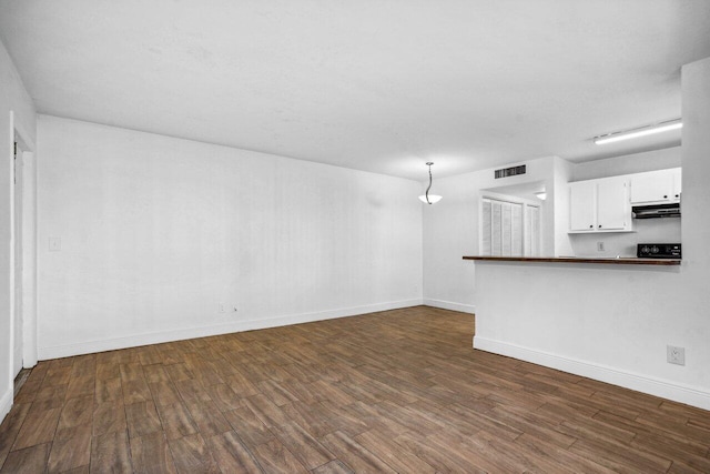 unfurnished living room featuring dark hardwood / wood-style flooring