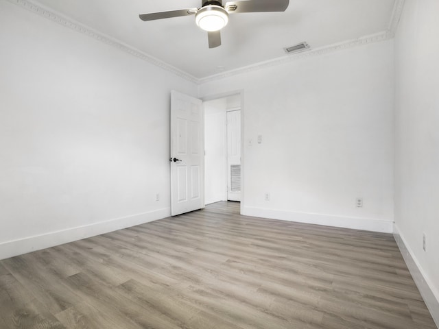 spare room with ornamental molding, wood-type flooring, and ceiling fan