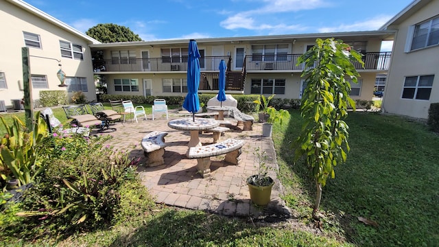 view of community with a yard and a patio