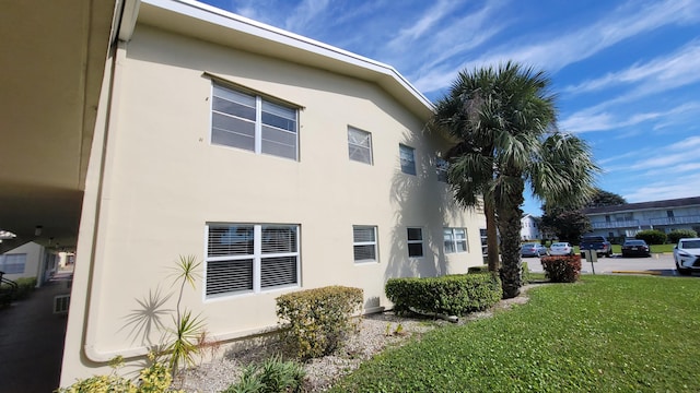 view of side of home with a yard