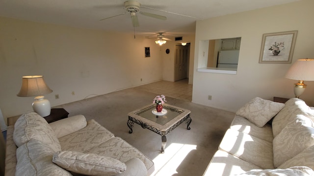 carpeted living room with ceiling fan