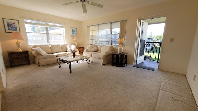 carpeted living room with ceiling fan