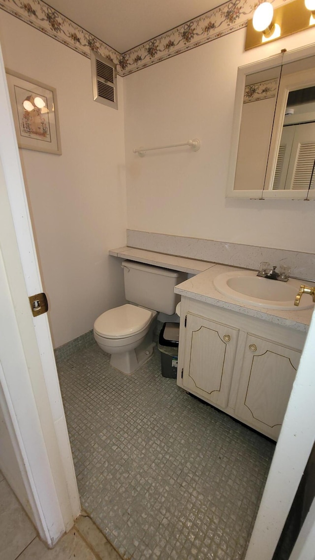 bathroom featuring tile patterned floors, vanity, and toilet