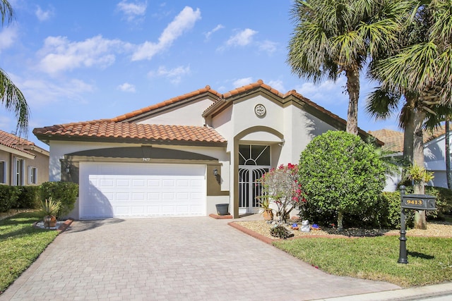 mediterranean / spanish-style home with a garage