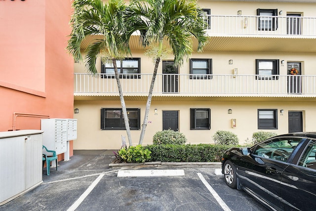 view of building exterior with uncovered parking