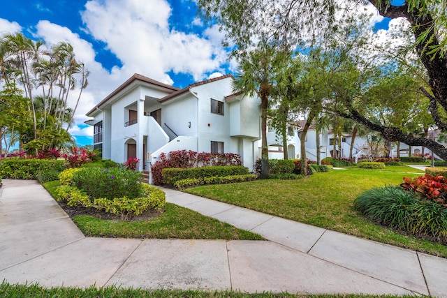 mediterranean / spanish house featuring a front yard