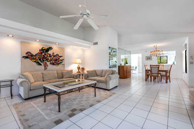 living room featuring lofted ceiling, ceiling fan with notable chandelier, and light tile patterned floors