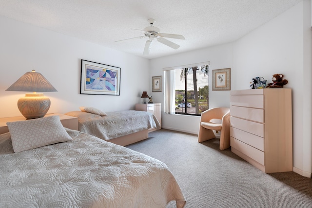 carpeted bedroom with ceiling fan and a textured ceiling