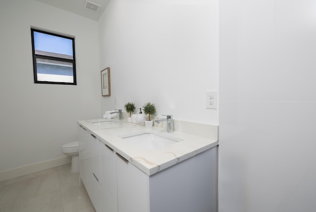 bathroom featuring vanity, toilet, and tile patterned flooring