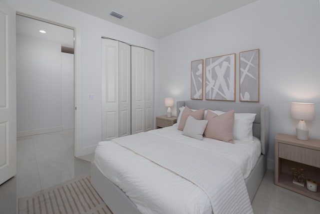 bedroom with light tile patterned flooring and a closet