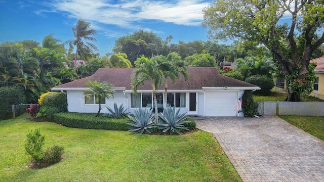 ranch-style home with a garage and a front yard