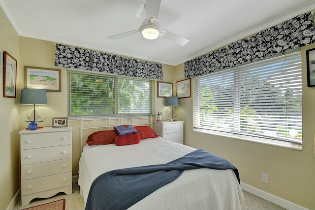 bedroom featuring multiple windows, ornamental molding, and ceiling fan