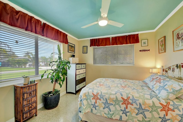 bedroom with ceiling fan and ornamental molding