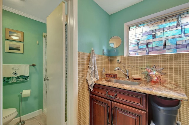 bathroom featuring crown molding, tile patterned flooring, backsplash, vanity, and toilet