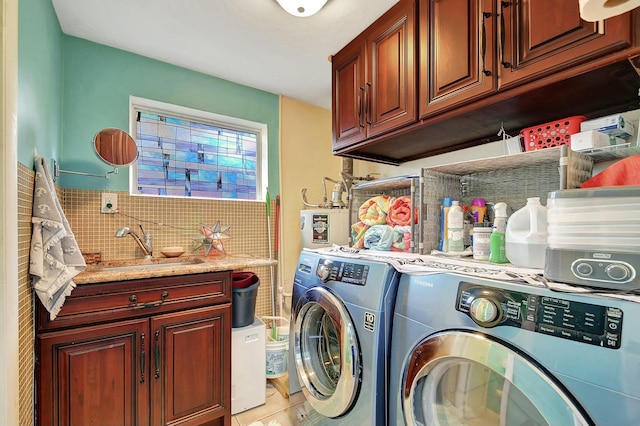 laundry area with cabinets, washing machine and dryer, sink, and light tile patterned floors