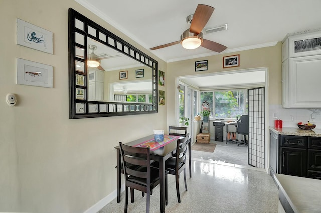 dining space with crown molding and ceiling fan