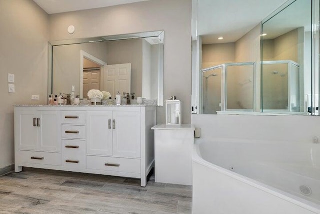 bathroom with vanity, plus walk in shower, and wood-type flooring