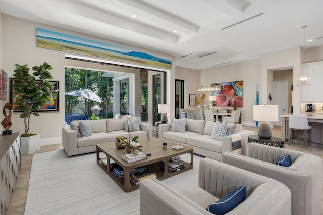 living room with beam ceiling, light parquet floors, and a chandelier