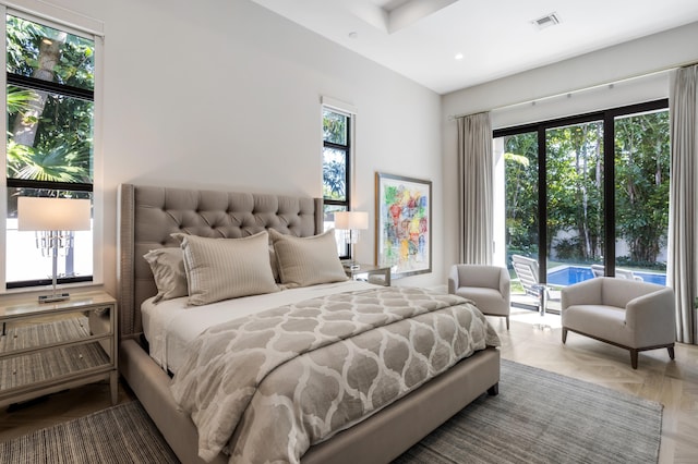 bedroom with parquet flooring and access to outside