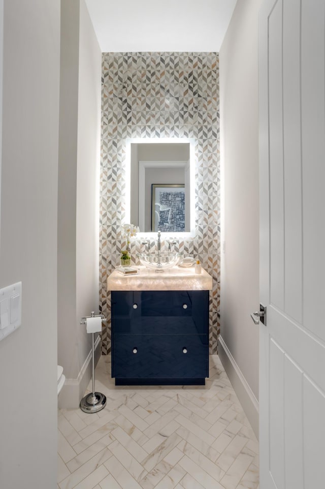 bathroom featuring vanity and toilet