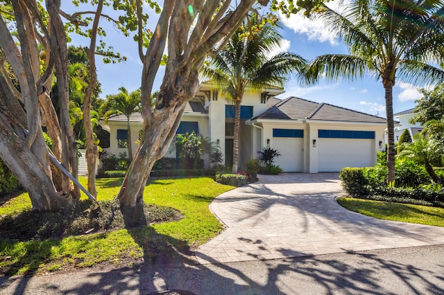 view of front of home with a garage and a front yard