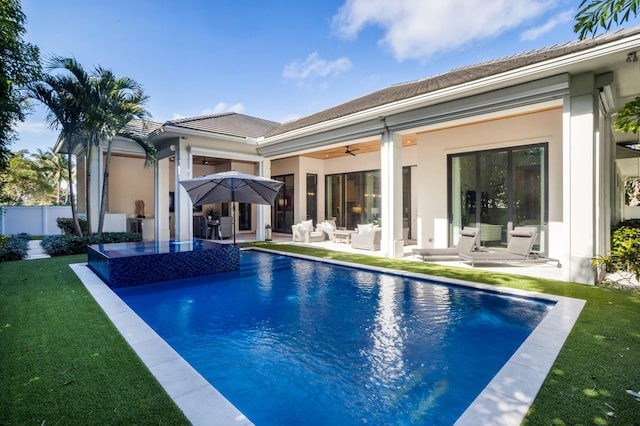 exterior space featuring ceiling fan, a patio, and a lawn