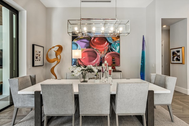 dining area with parquet floors and an inviting chandelier