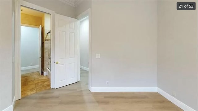 interior space featuring ornamental molding and light wood-type flooring