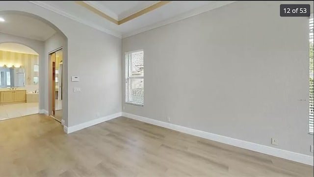 unfurnished room featuring crown molding and hardwood / wood-style floors