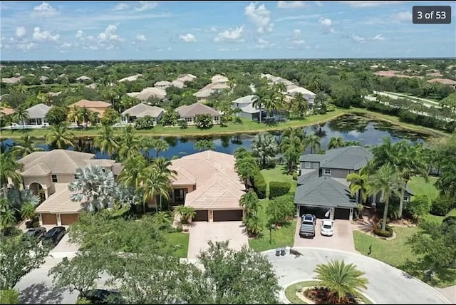 drone / aerial view with a residential view and a water view