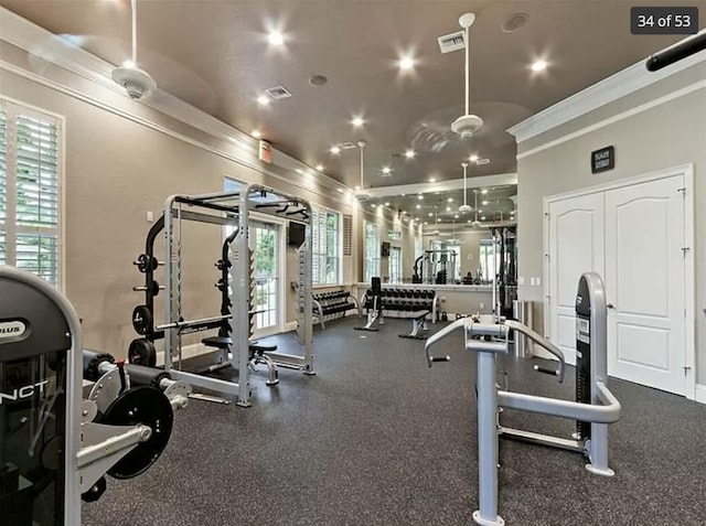 gym with ornamental molding and plenty of natural light