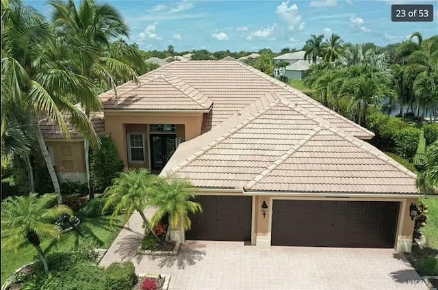 mediterranean / spanish-style home with a garage