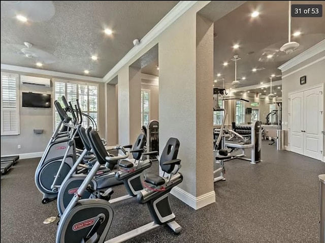 exercise room featuring crown molding, a textured ceiling, and an AC wall unit