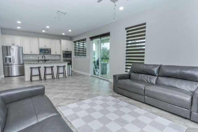 living room with sink and ceiling fan