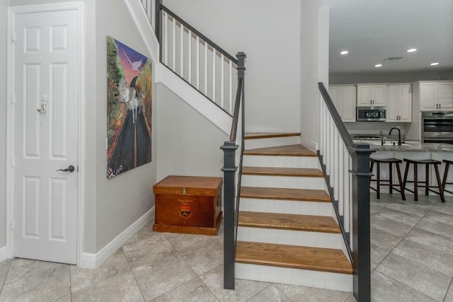 stairs featuring sink