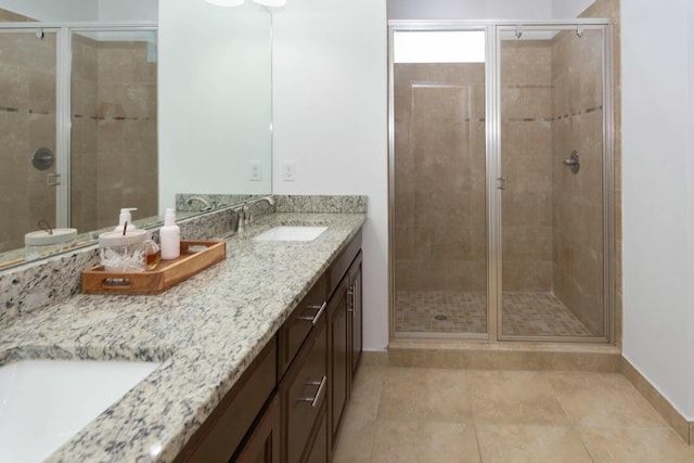 bathroom with vanity, an enclosed shower, and tile patterned flooring