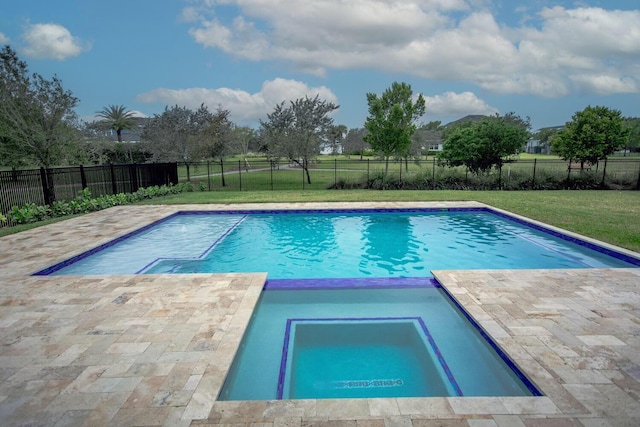 view of pool with an in ground hot tub, a patio area, and a lawn