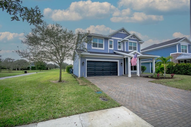 view of front of property with a garage and a front lawn