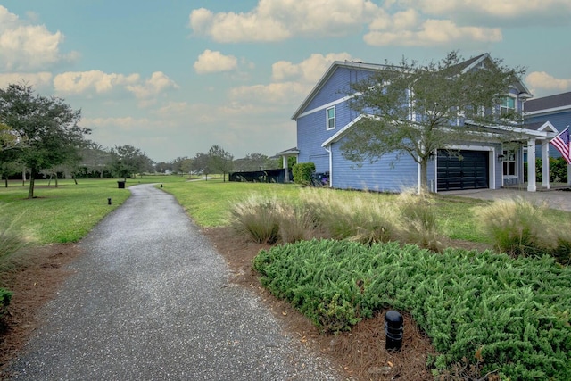 view of side of property with a garage and a lawn